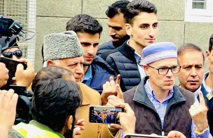 Dr Abdullah’s son, Omar Abdullah, and grandsons  Zahir Abdullah and Zamir Abdullah, cast their ballot at a polling station at Burnhall School in Srinagar's Sonawar neighbourhood.