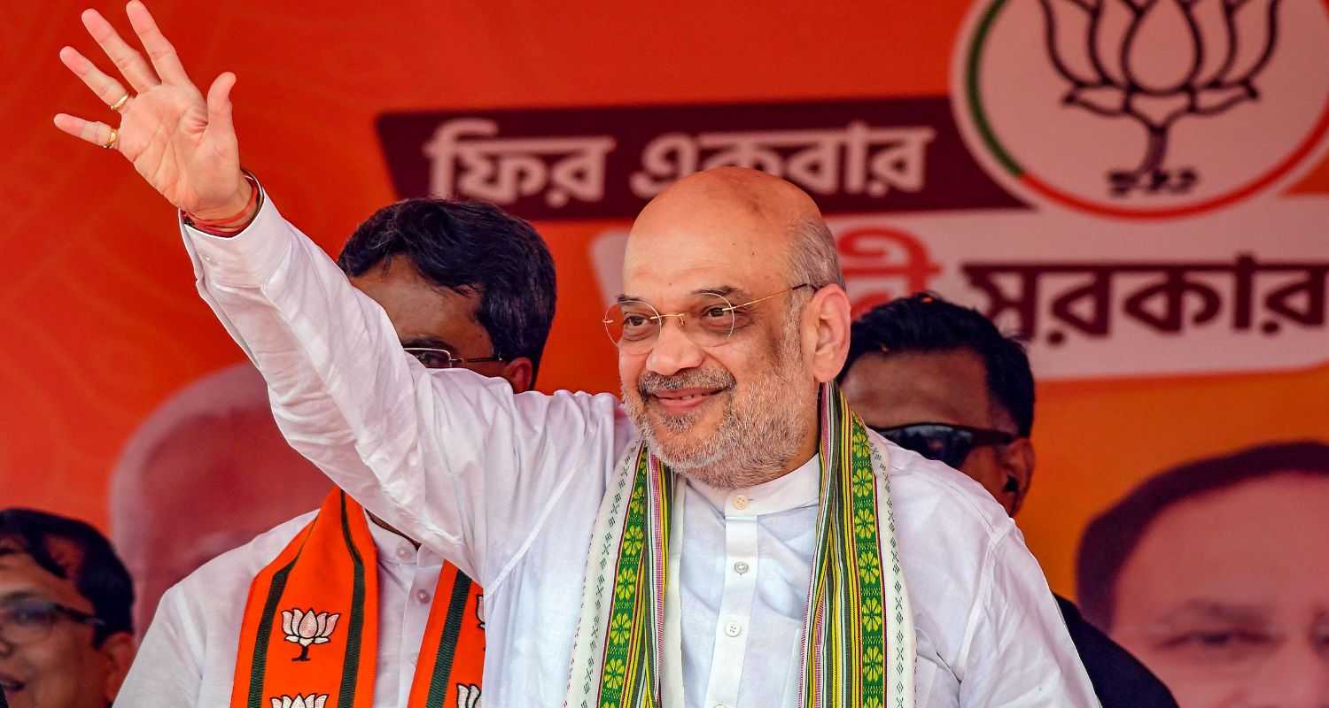 Union Home Minister and BJP leader Amit Shah waves at supporters during a public meeting, ahead of Lok Sabha elections, in Kumarghat, Tripura on Monday.