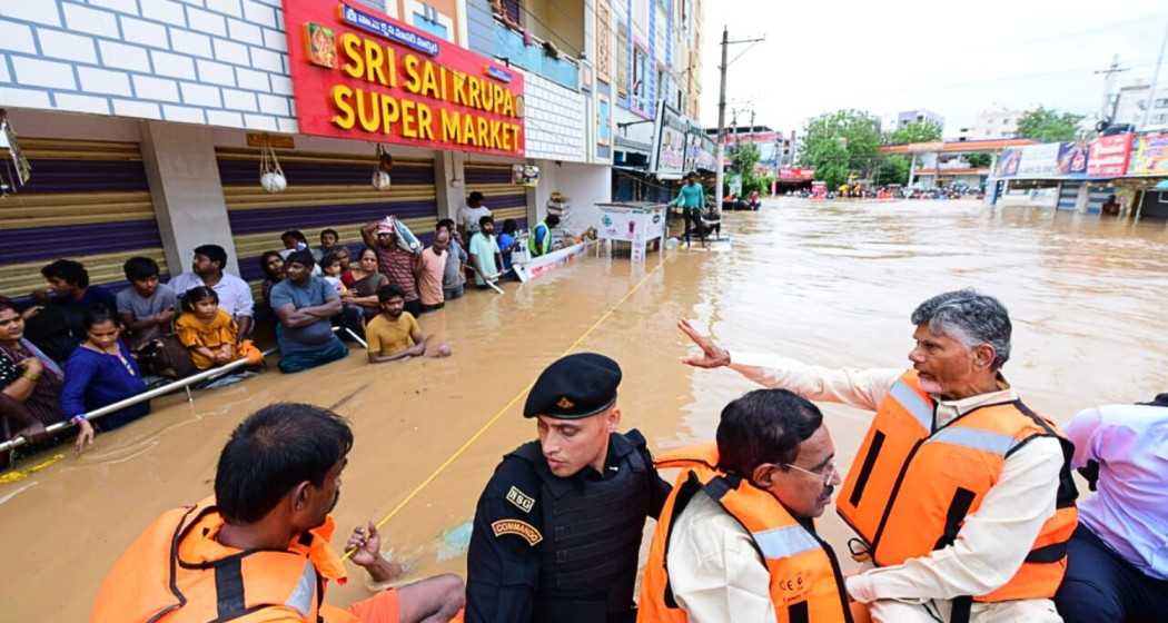 Andhra Pradesh chief minister N Chandrababu Naidu with others during a visit to a flood-affected area in Vijayawada. 