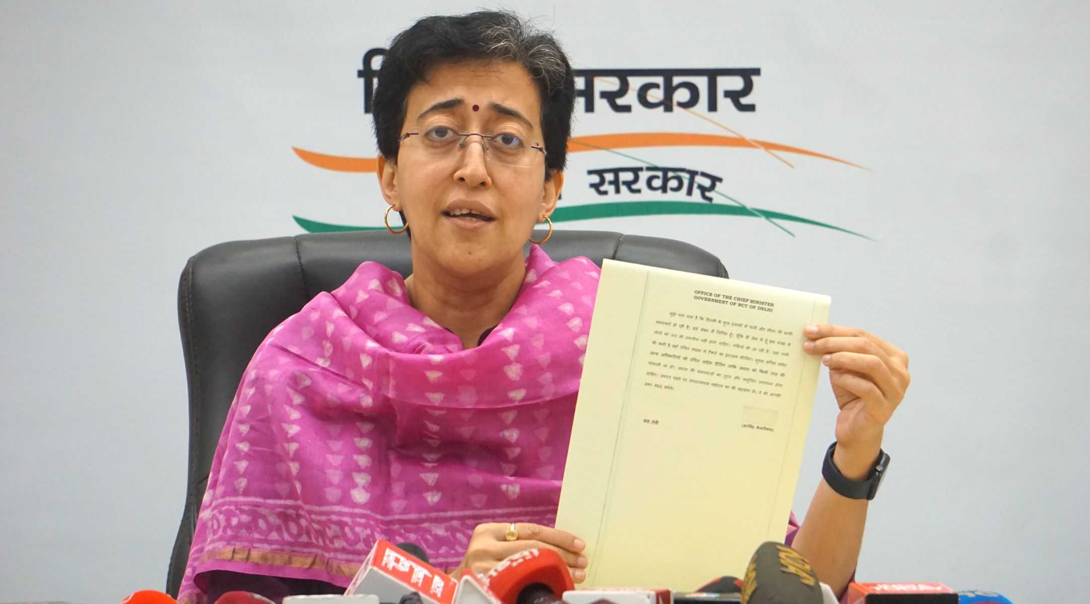 Delhi Minister and AAP leader Atishi shows Delhi Chief Minister Arvind Kejriwal's first work orders issued from ED custody (PTI).