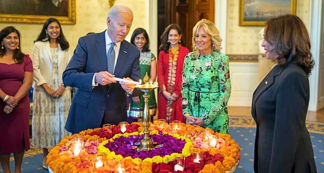 US President Joe Biden lights a lamp as First lady Jill Biden and Vice-President Kamala Harris look on during an event to celebrate Diwali, at the White House in Washington. 