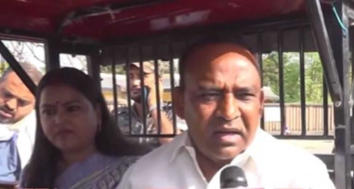 Kumar Sarvjeet arrives in an e-rickshaw to cast his ballot. 