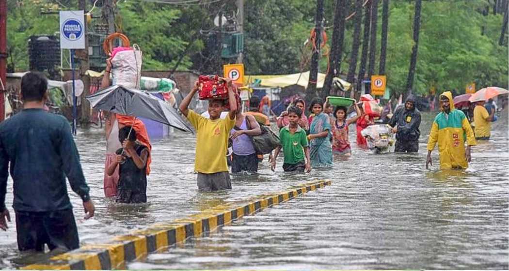 Residents navigate through floodwaters in Bihar, highlighting the urgent need for improved flood management and infrastructure.