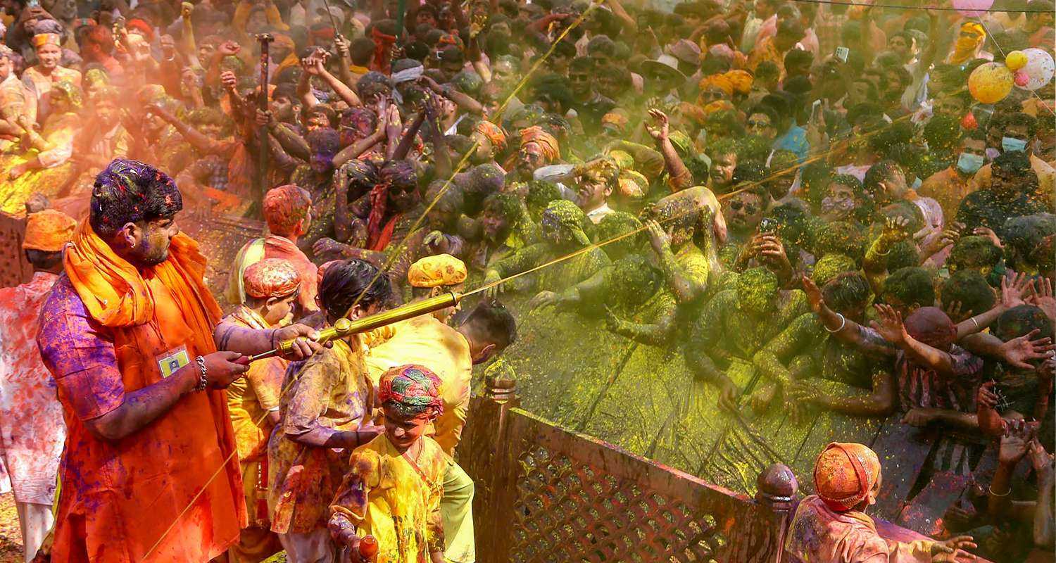 Mathura: Devotees celebrate 'Chadi Maar' Holi in the Gokul town near Mathura, 
