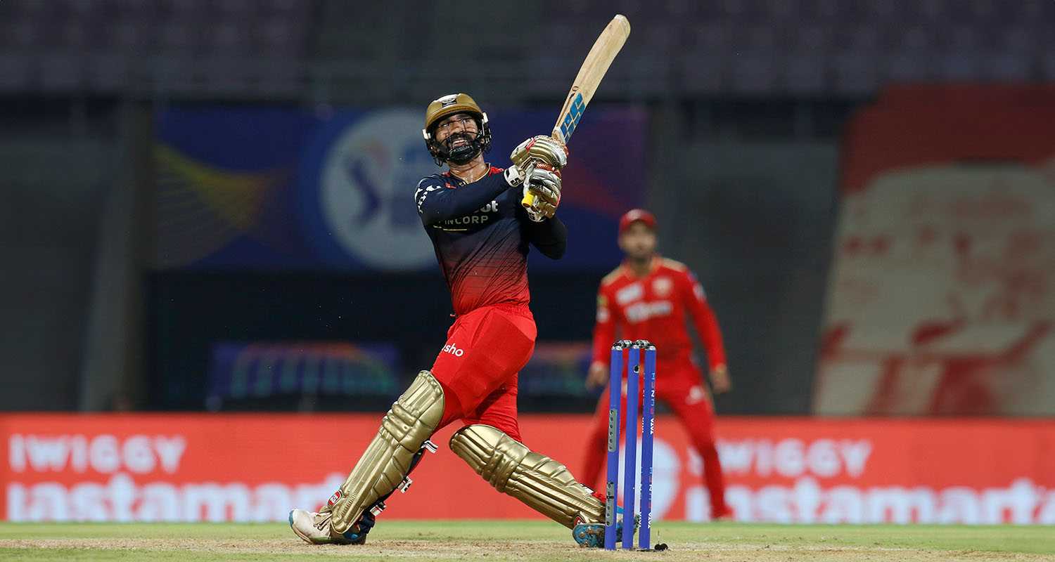 Batsman Dinesh Karthik hits a sixer during a match against Punjab Kings in IPL 2023.