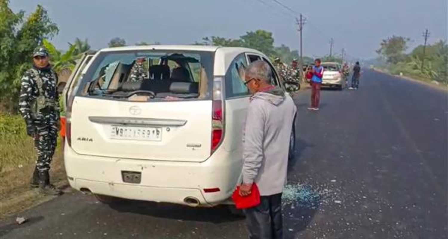 Security personnel with others stand near a vehicle which was allegedly damaged by the supporters of TMC leader during a raid by ED officials, in West Bengal's North 24 Parganas district on January 5.