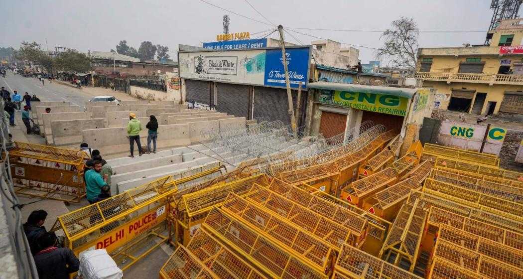 Road blocks being placed at Singhu Border ahead of the scheduled 'Delhi Chalo' march by the protesting farmers, in New Delhi on Monday.