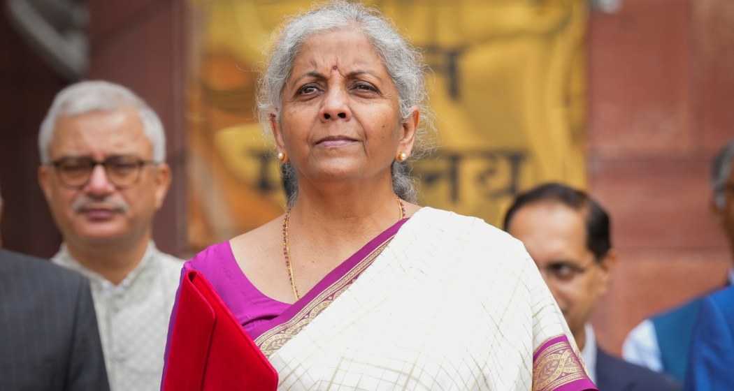 Union Finance Minister Nirmala Sitharaman shows a red pouch carrying the Budget documents, outside the Finance Ministry in North Block before leaving for the Parliament where she will table the Union Budget 2024-25, in New Delhi, Tuesday, July 23, 2024. 