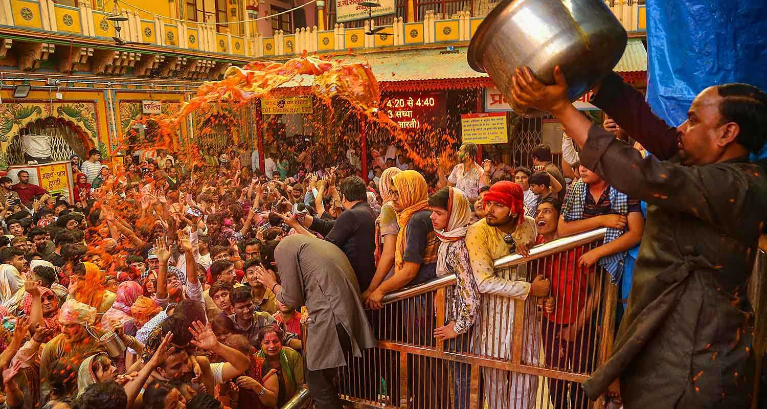 Devotees celebrate with colours during Holi celebration at the Dwarkadhish Temple, in Mathura