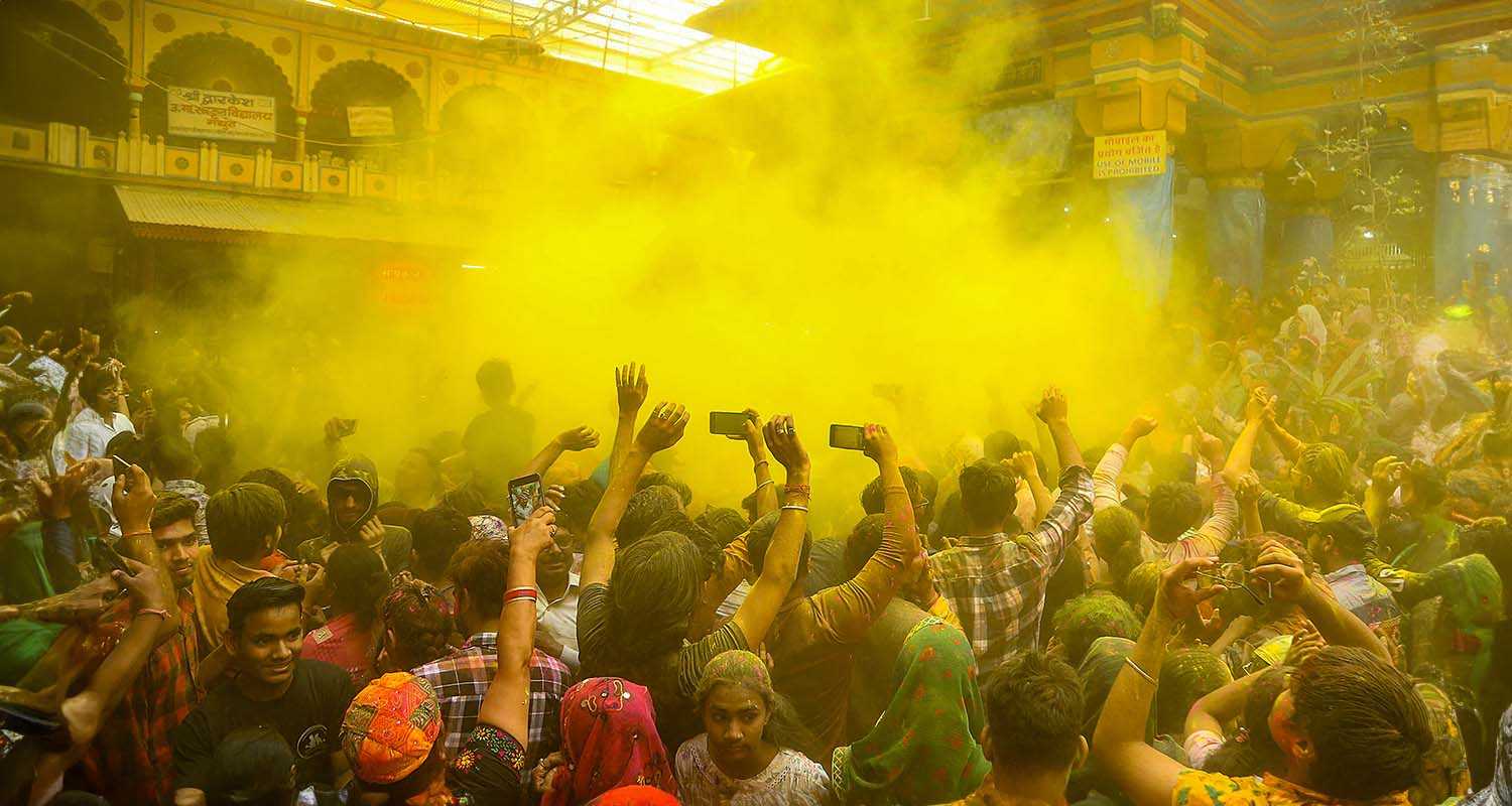 Devotees celebrate with colours during Holi celebration at the Dwarkadhish Temple, in Mathura