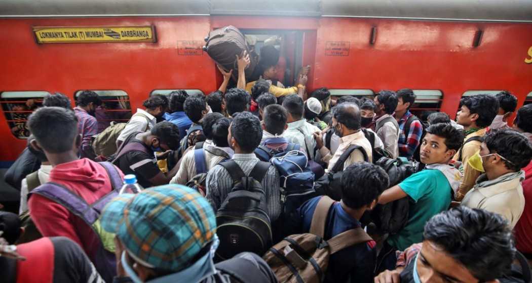 A crowded Indian railway train showcases the bustling demand for affordable travel options as passengers jostle for space.