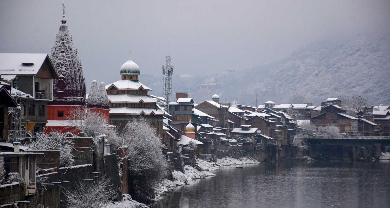 the Jhelum River in Jammu and Kashmir, with fresh snowfall.