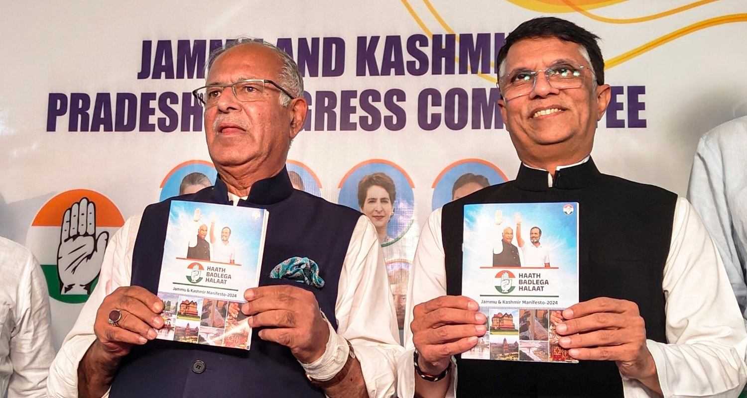 Congress leader Pawan Khera with JKPCC chief Tariq Hameed Qara releases party's manifesto for upcoming Assembly elections, in Srinagar, Monday.