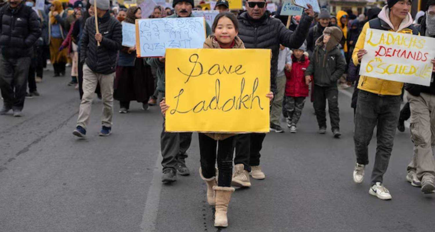 A child carries a sign during Ladakh Sixth schedule protests.