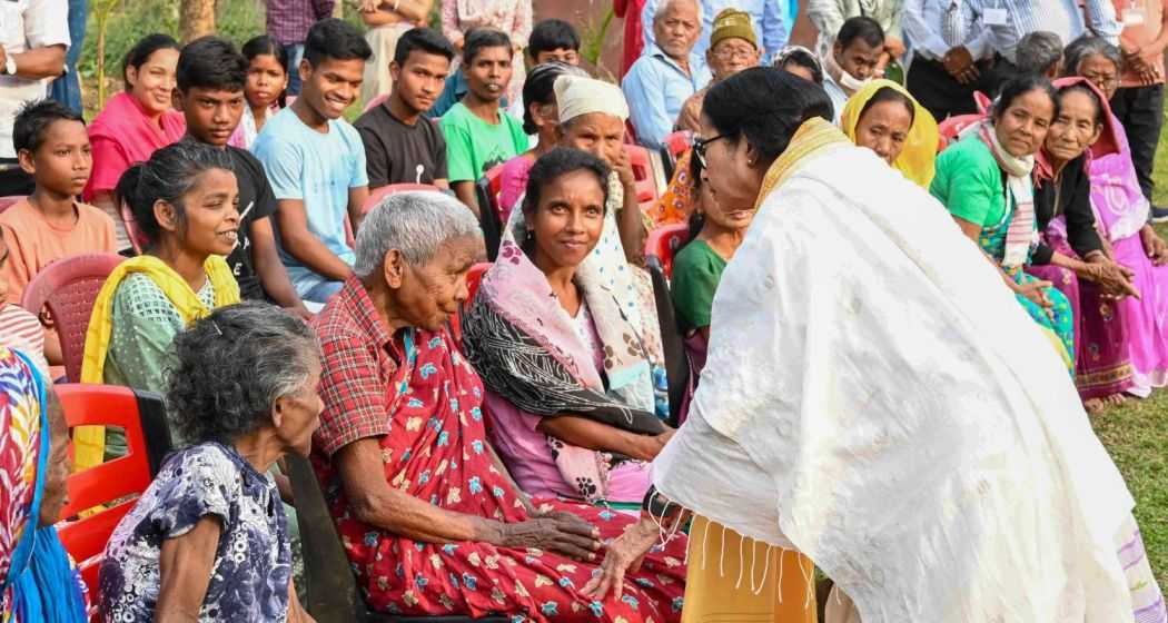 West Bengal Chief Minister Mamata Banerjee interacts with elderly people at an old age home during her visit after a recent storm that left at least five people dead and rendered over 200 homeless, in Jalpaiguri district on Tuesday. 