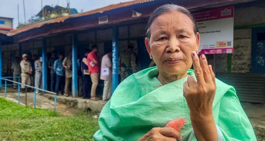 A voter shows her finger marked with indelible ink after casting her vote for Lok Sabha elections, during repolling at 11 polling stations in the Inner Manipur Lok Sabha constituency, Monday.