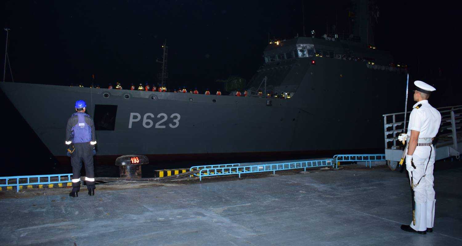 Indian Navy soldier stands in attention while welcoming a Sri Lankan Navy vessel.