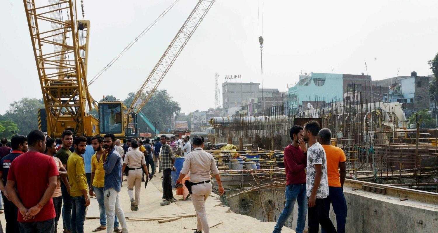 People gather at Patna Metro tunnel construction site where two people died and many were injured.