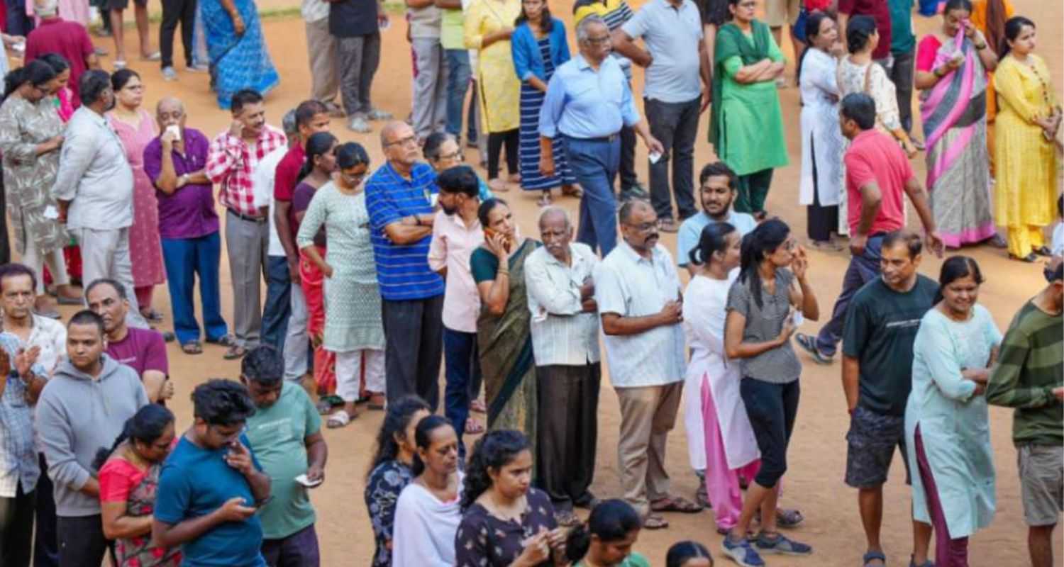 People stand in queue to cast vote.