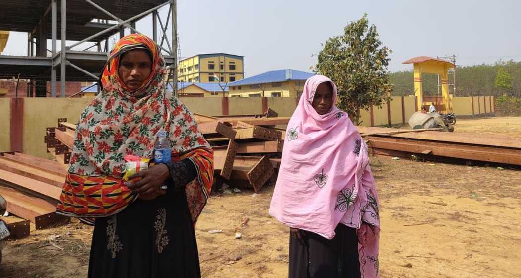 Rohingya refugees pose in front of the foreigner transit camp in Matia, Assam, highlighting their ongoing struggle and demand for relocation.