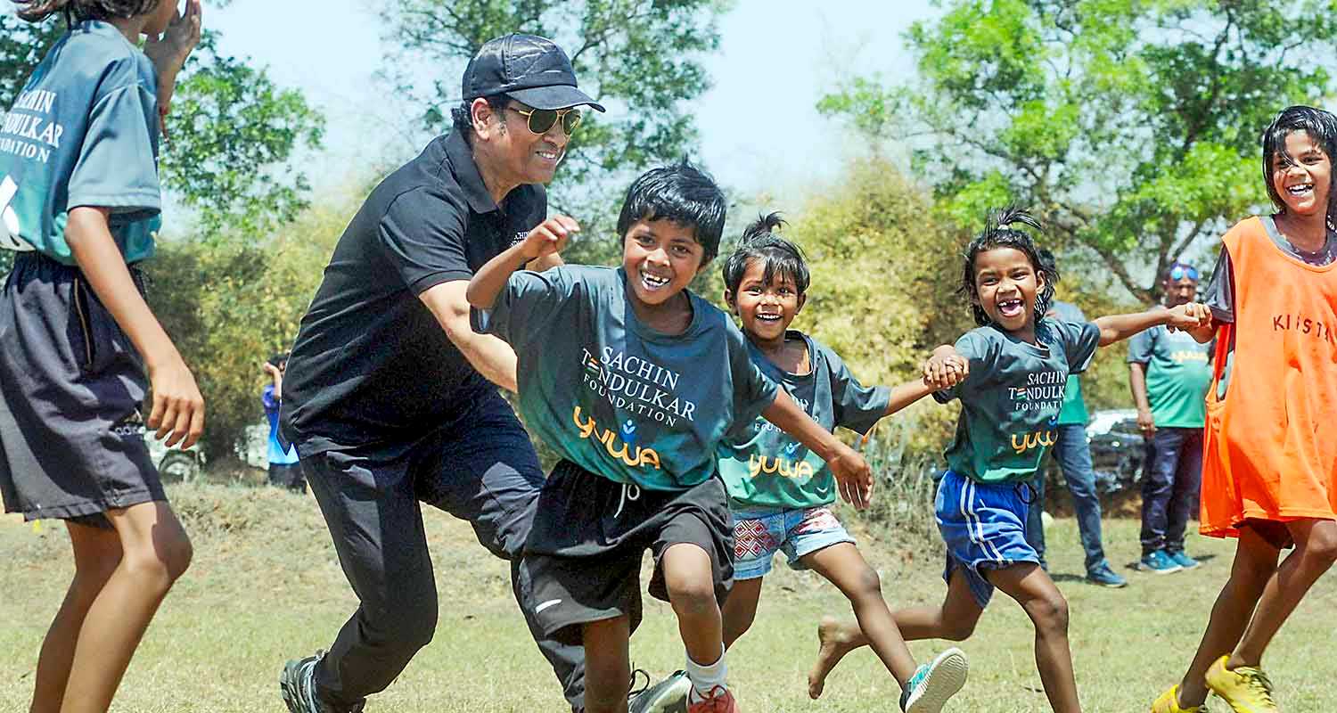 Former cricketer Sachin Tendulkar with wife Anjali Tendulkar pose for group photos with budding football players of Yuwa Foundation, in Ranchi