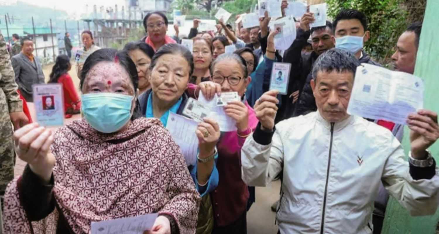 People show their ID cards as they wait to cast their votes for Lok Sabha elections, in Namchi district, Sikkim on Friday, April 19, 2024.