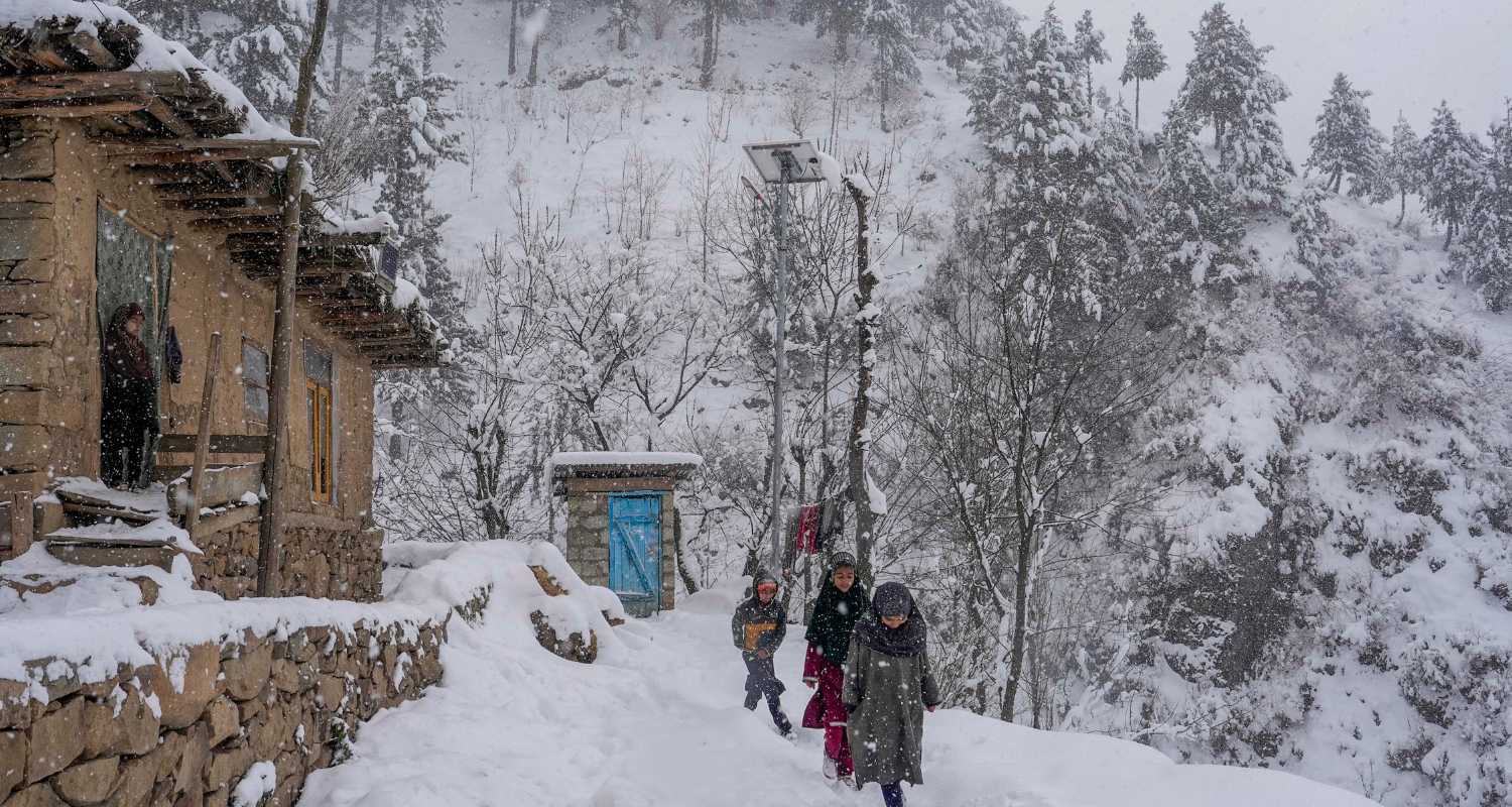 Children walking in the snow on the outskirts of Srinagar