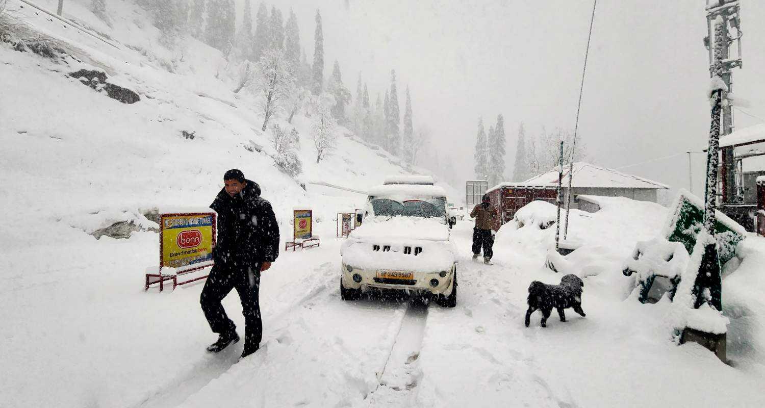 Snow-covered road at the Atal Tunnel Rohtang South Portal during snowfall. 