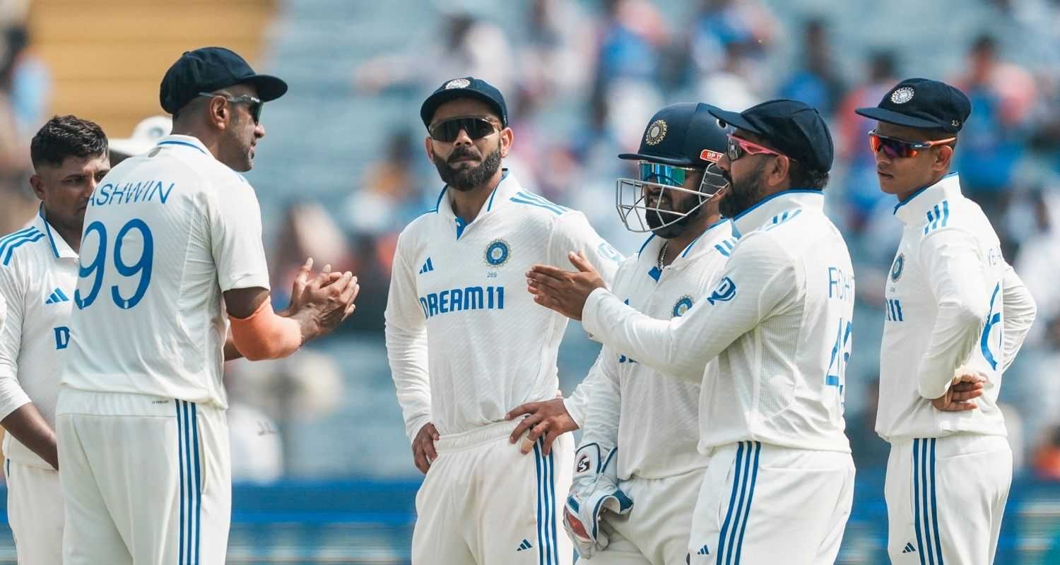 India's players wait during an unsuccessful DRS review for the wicket of New Zealand's Devon Conway on the first day of the second test cricket match between India and New Zealand, at the Maharashtra Cricket Association Stadium, in Pune.