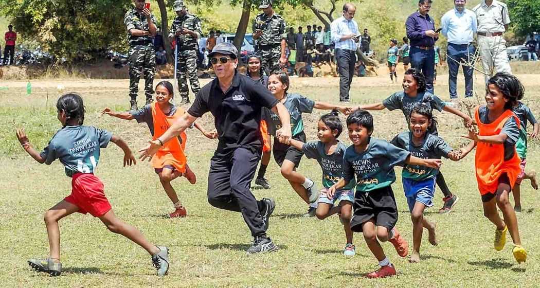 Former cricketer Sachin Tendulkar with wife Anjali Tendulkar pose for group photos with budding football players of Yuwa Foundation, in Ranchi.