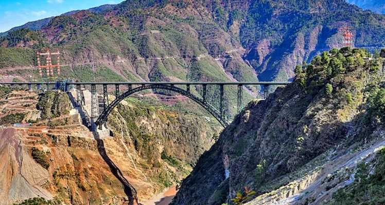 The image shows the Chenab Rail Bridge, a key component of the Udhampur-Srinagar-Baramulla Railway Link (USBRL) project, situated over the Chenab river in Reasi district, known as the world’s highest railway bridge. 