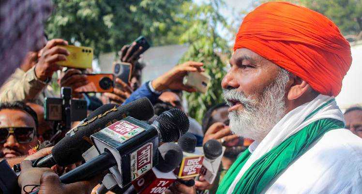 Bharatiya Kisan Union spokesperson Rakesh Tikait speaks with the media during a protest at DM office. 