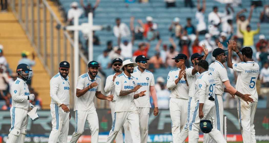 New Zealand's Tim Southee with his teammates celebrates the wicket of India's captain Rohit Sharma during the first day of the second test cricket match between India and New Zealand, at the Maharashtra Cricket Association Stadium, in Pune.