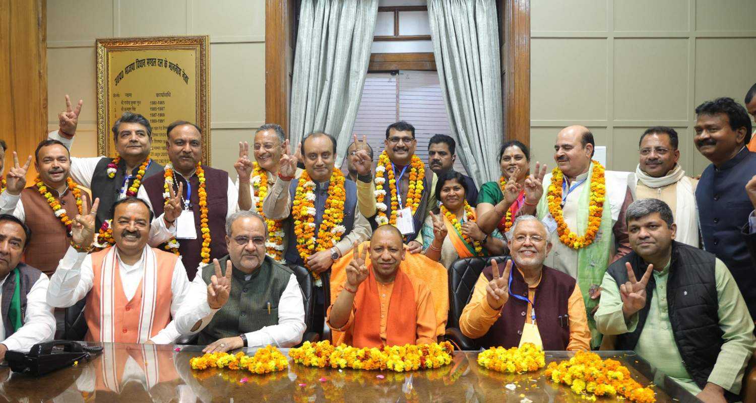 Victorious candidates show the victory sign along with Uttar Pradesh Chief Minister Yogi Adityanath.