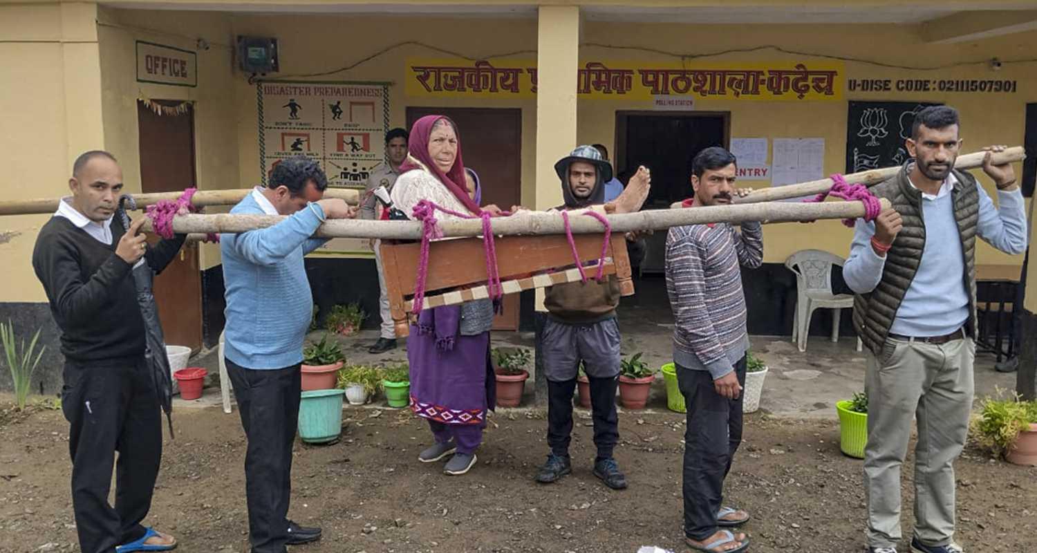 People carry an elderly woman on a palanquin to a polling booth to cast her vote during the Panchayat elections at Seri village, in Shimla, Himachal Pradesh, Saturday, May 30, 2026. 