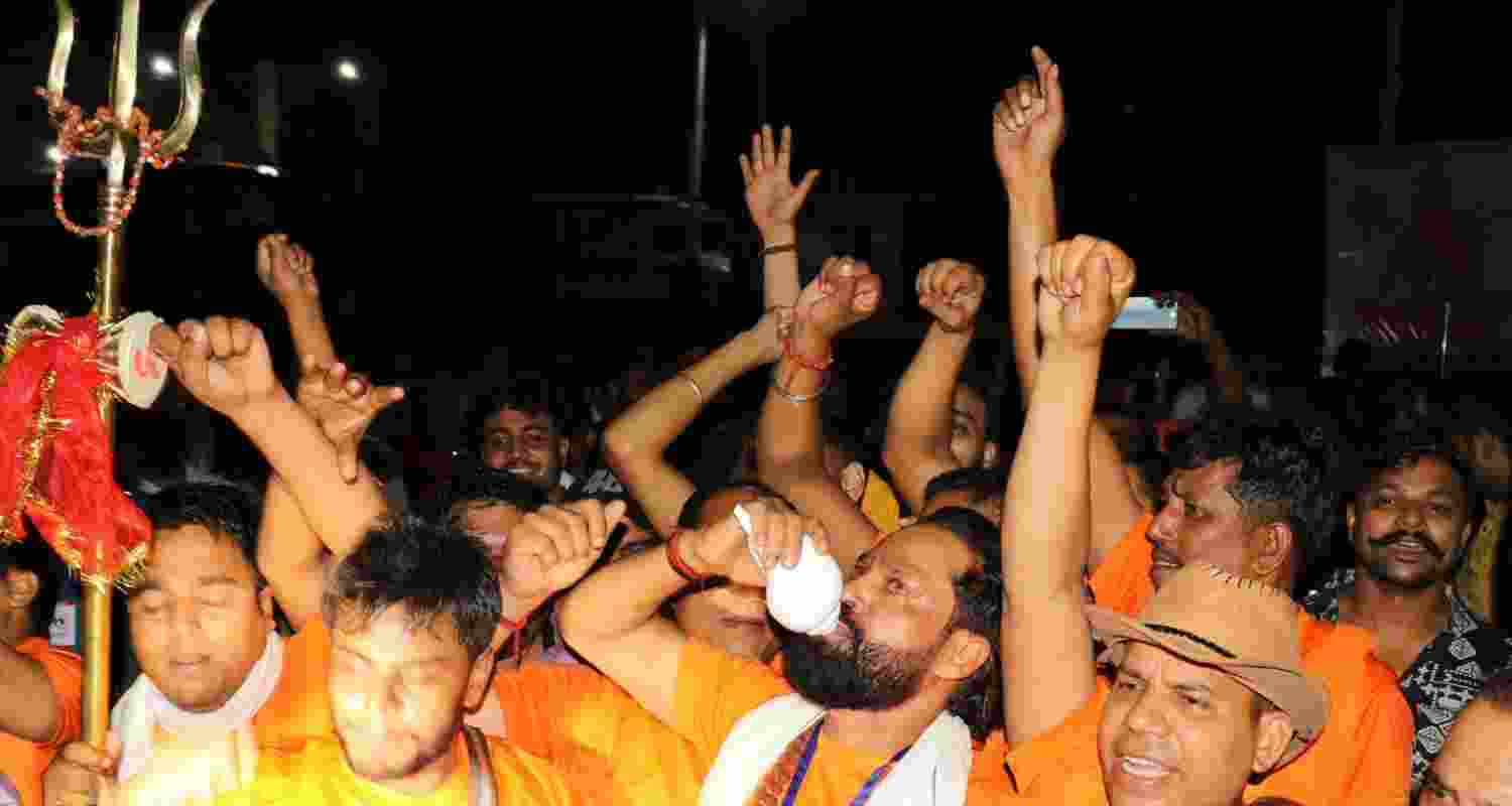 Pilgrims shout slogans as the first batch of pilgrims leaves for the Amarnath Yatra, in Jammu, Friday. 