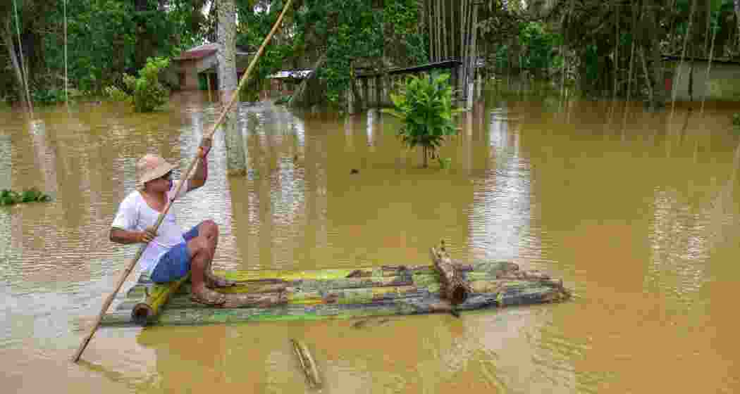 A villager uses a banana raft in the flood-affected Patiapam village, in Nagaon district, Wednesday, July 3, 2024. 