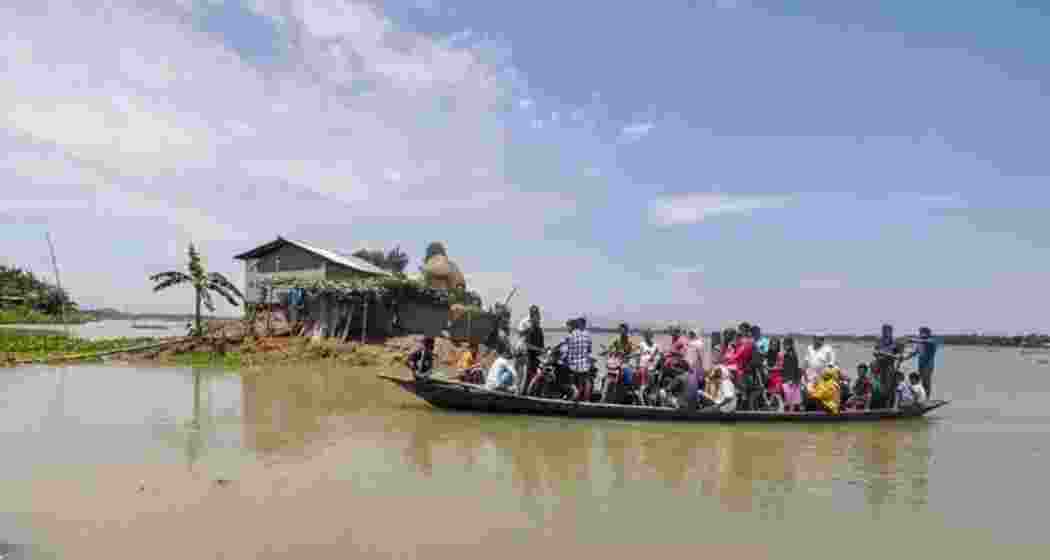 Villagers wade across a flood-affected area due to monsoon rains at Balimukh village in Assam's Morigaon back in 2018. File photo.