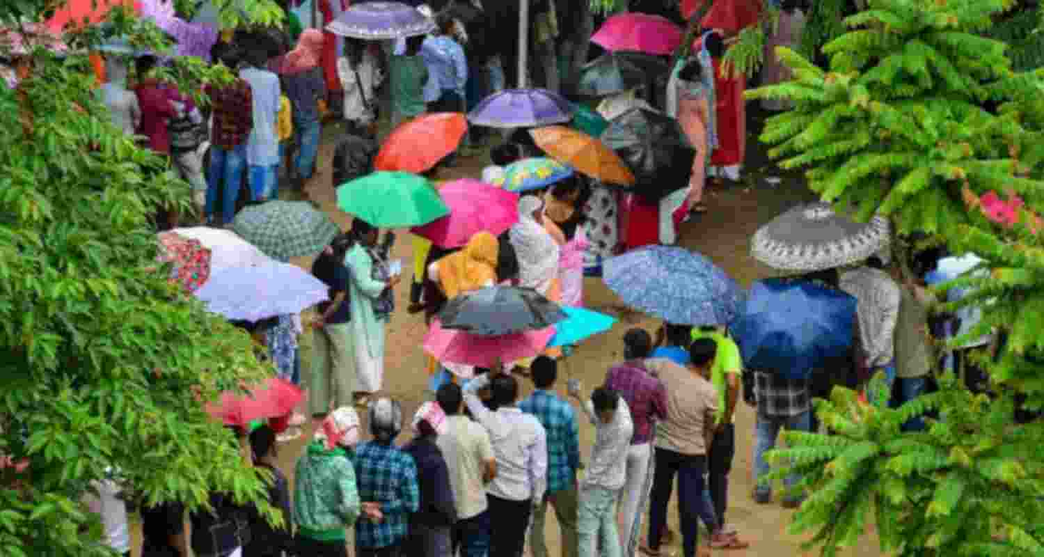 Assam votes amid rain.
