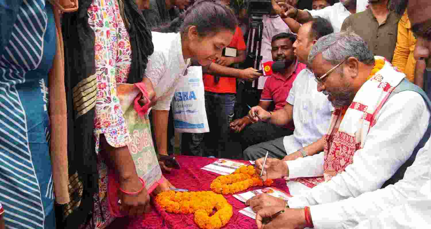  State BJP president Babulal Marandi helps women and girls fill up Go Go Didi forms of BJP in Ranchi on Tuesday. 