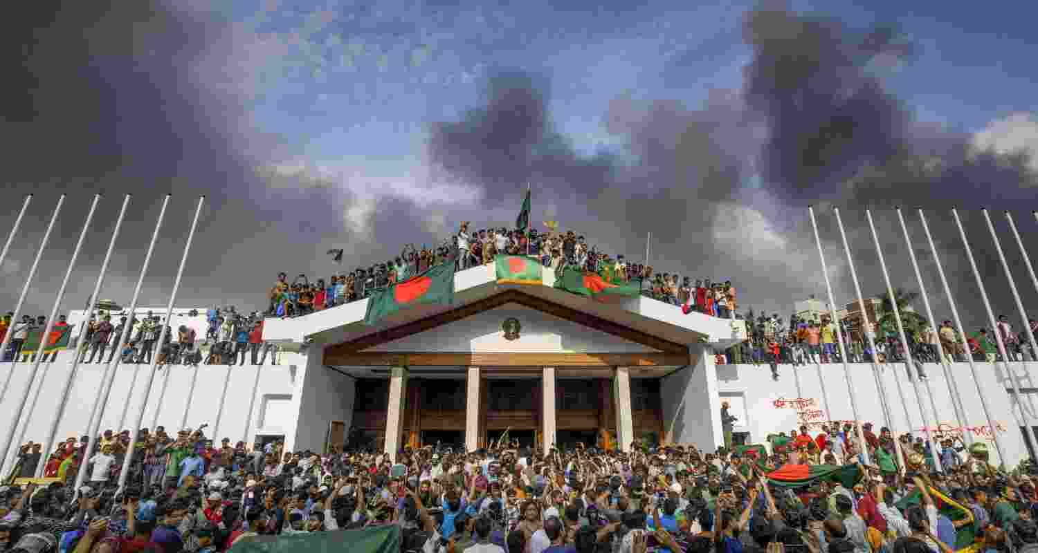 People gather around the residence of Bangladeshi prime minister in Dhaka, Bangladesh, 05 August 2024. In an address to the nation, Chief of Army Staff General Waker-Uz-Zaman announced that Prime Minister Sheikh Hasina has resigned after weeks of unrest and an interim government will be formed to run the country. 