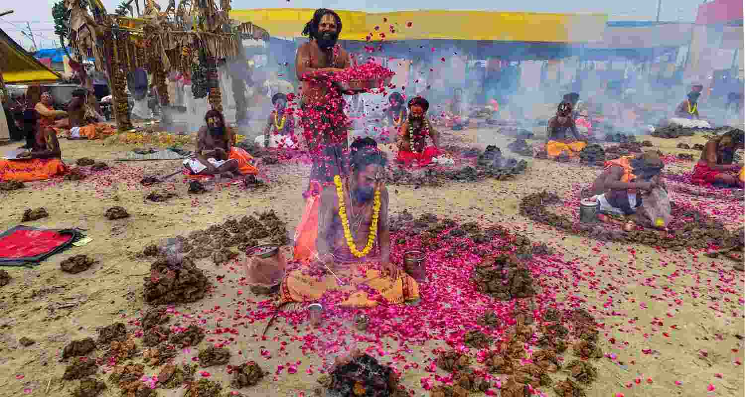  Hindu sages burn cow-dung cakes as they perform a ritual on the occasion of the Basant Panchami festival during the annual religious 'Magh Mela' festival at Sangam, in Prayagraj, Uttar Pradesh.