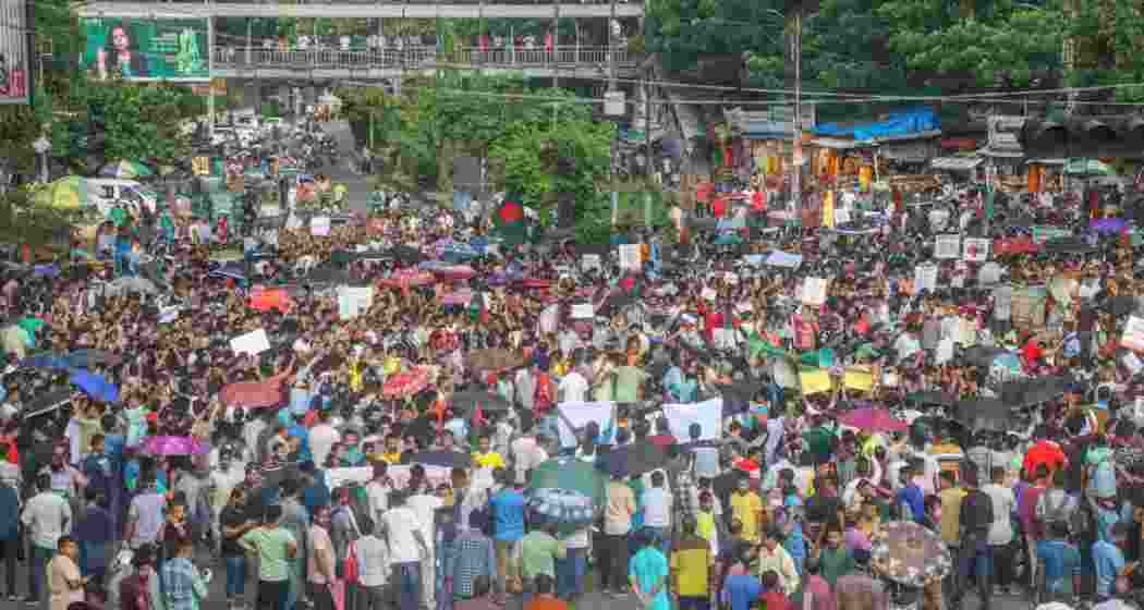 Bangladesh Hindu community members participate in a protest and block the Shahbagh intersection in Dhaka.