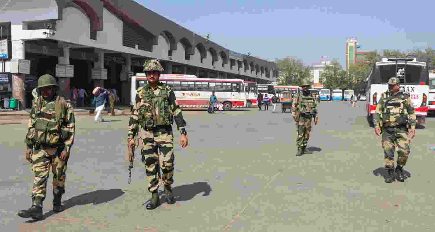 Security personnel keep a vigil at the Rohtak Bus Depot during 'Bharat Bandh', in Rohtak, Friday, Feb. 16, 2024. The Samyukta Kisan Morcha (SKM) has called for the 'Bharat Bandh' to press the BJP-led central government to accept farmers' demands, including a legal guarantee of minimum support price (MSP) for crops.