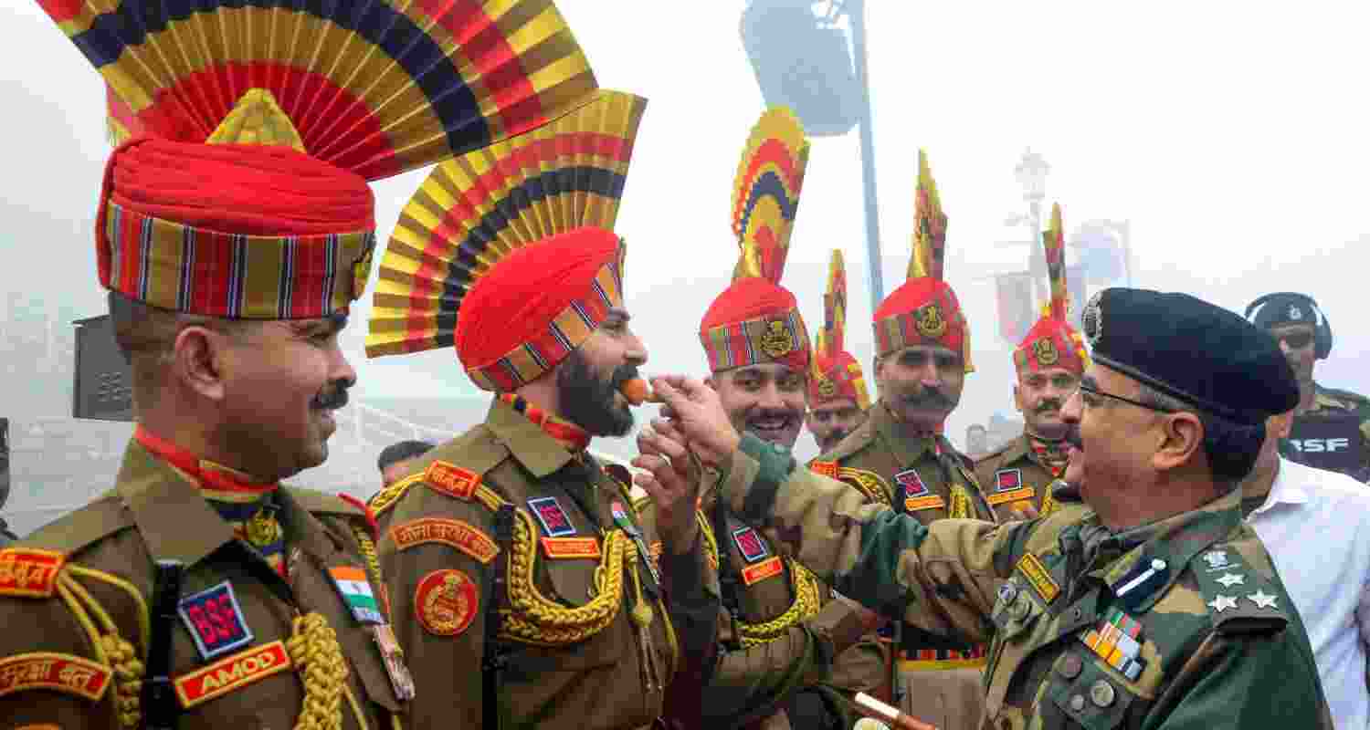 Celebrating the nation's protectors: DIG Sanjay Gaur of the Border Security Force (BSF) presents sweets to soldiers as part of the 75th Republic Day festivities at the Wagah-Atari border outpost between India and Pakistan, situated near Amritsar, Punjab. The BSF was established in response to the Indo-Pakistani War of 1965, with the mandate of "ensuring the security of India's borders and addressing related concerns."