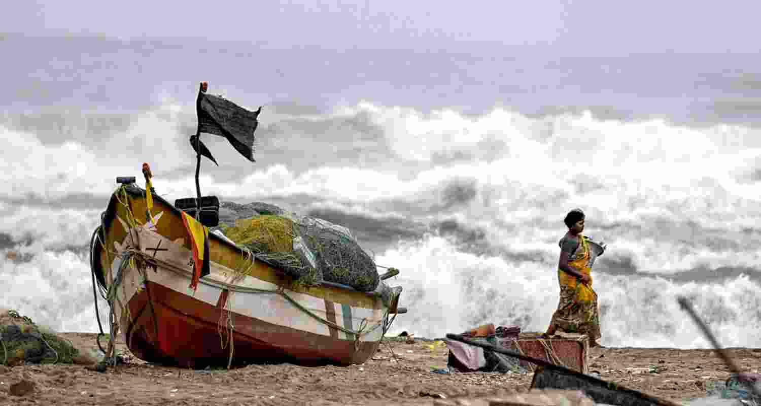 A fisherwoman in the coastal region of India during cyclone Michaung caused by climate change