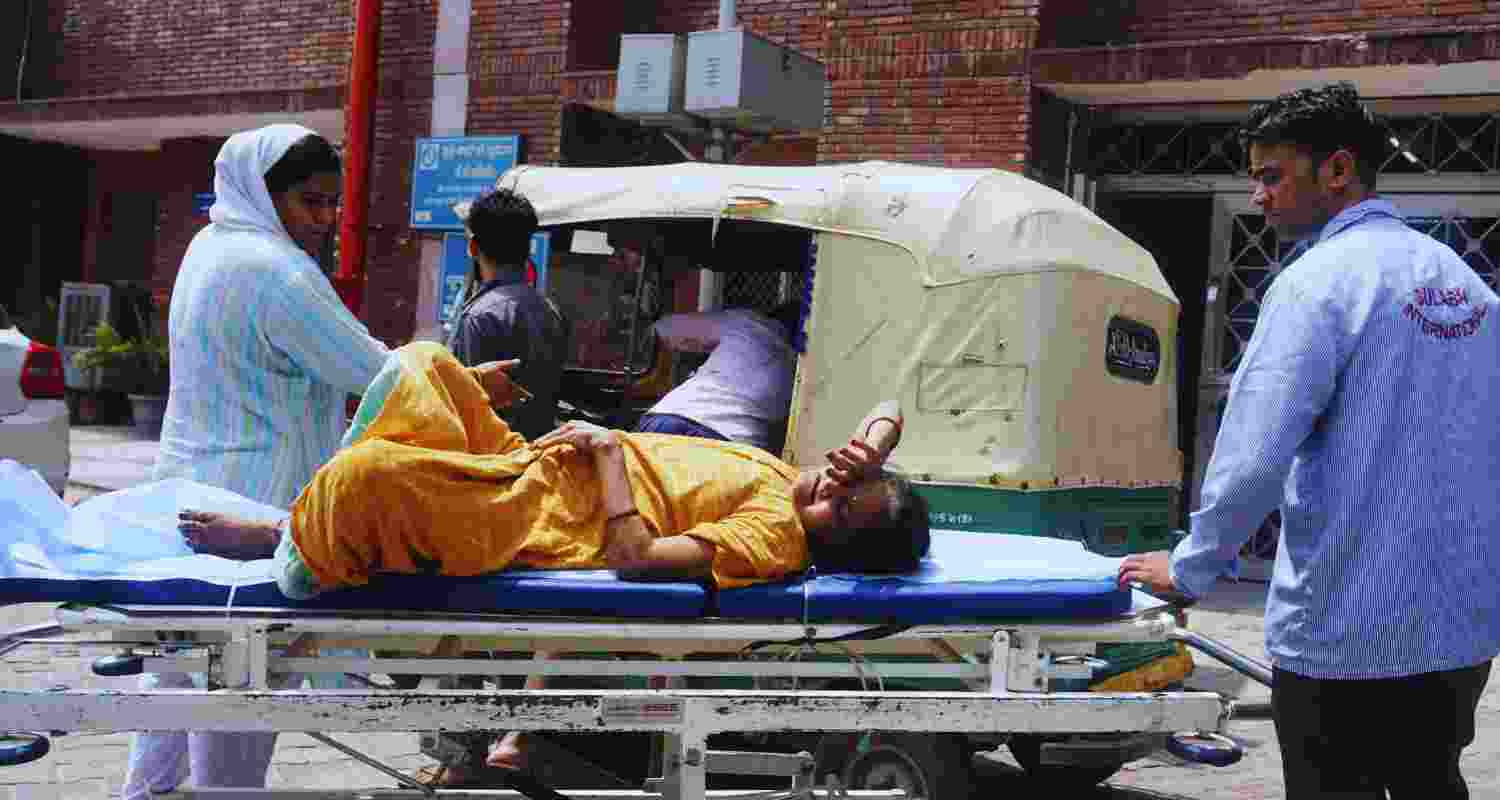 A woman suffering from a heat-related illness being brought to LNJP Hospital for treatment, as the national capital witnesses hot weather conditions, in New Delhi, Thursday, June 20, 2024. 