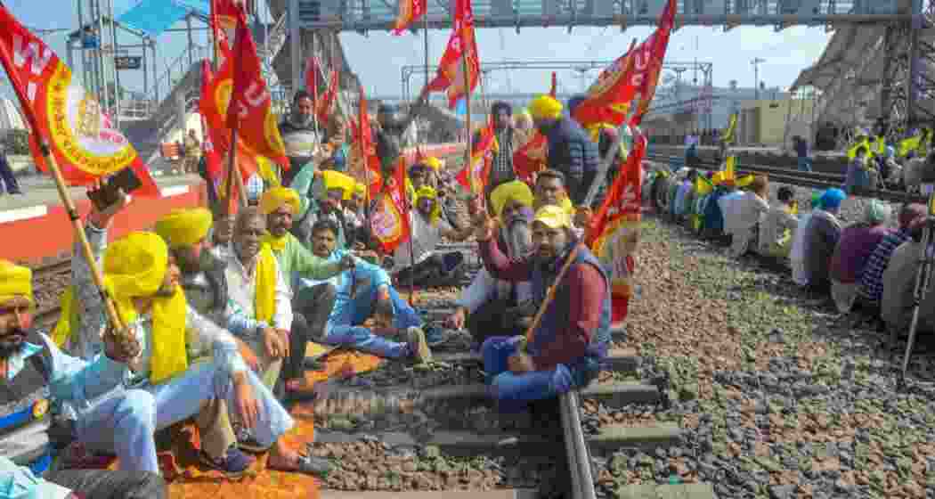 Members of various organisations block railway tracks at Rajpura as they stage 'rail roko' protest in support of farmers agitating at Punjab-Haryana Shambhu border, in Patiala, Thursday.
