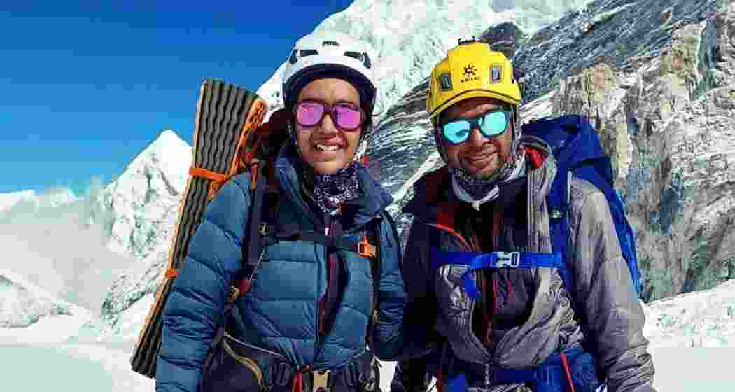 Kaamya Karthikeyan (left) and Commander S Karthikeyan celebrate their successful ascent of Mount Everest with a joyful pose.