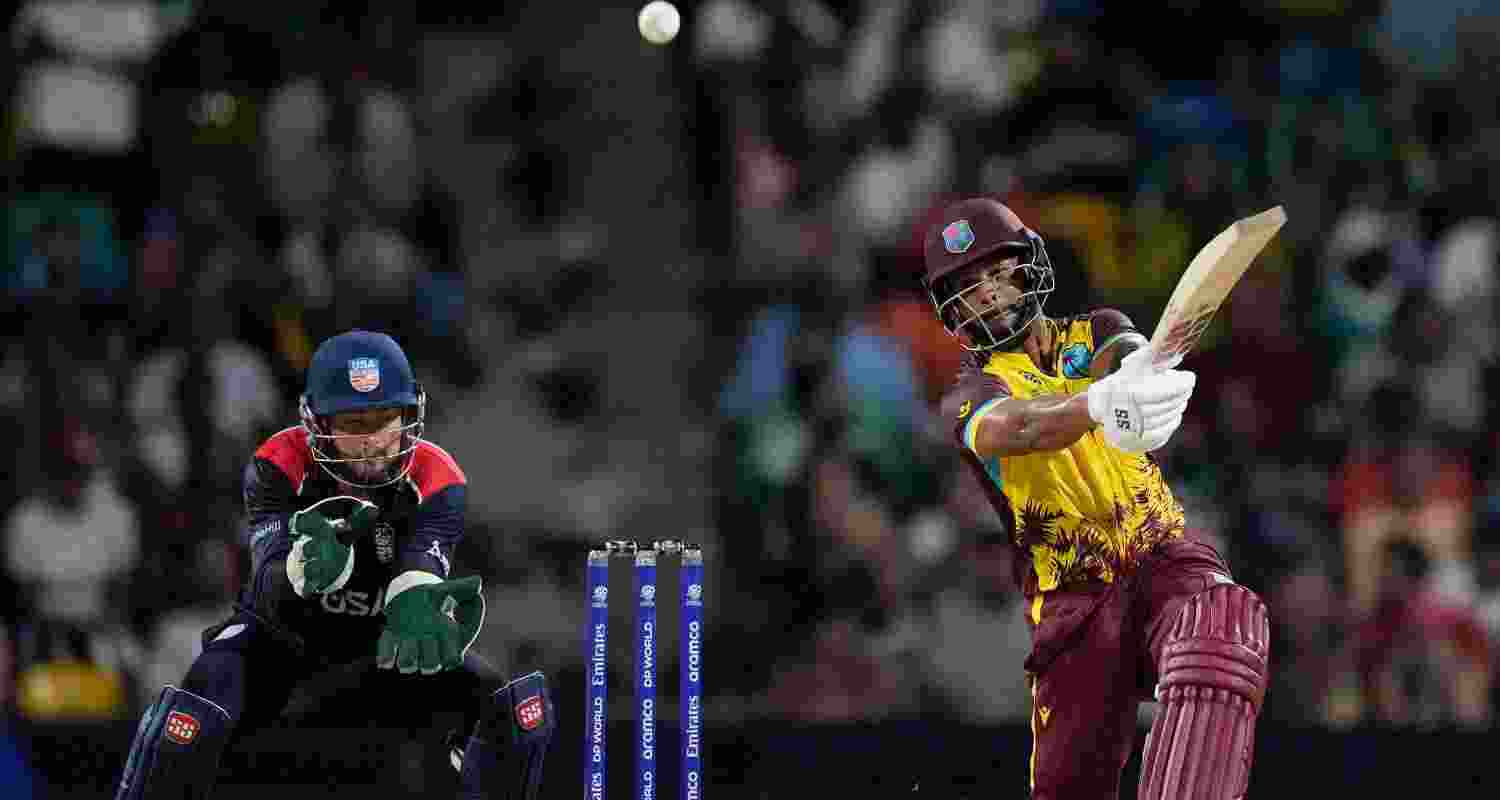 West Indies batsman Shai Hope smashes the ball for a sixer on the off side.